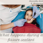 Kid sits on dental chair smiling at dentist who is using a mirror to check her teeth.