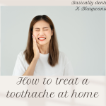 The image shows a young woman standing against a light, plain background. She has her eyes tightly closed and is pressing her hand against the side of her face, suggesting she is experiencing tooth pain or discomfort. Her expression clearly shows distress, which helps convey the feeling of a toothache.